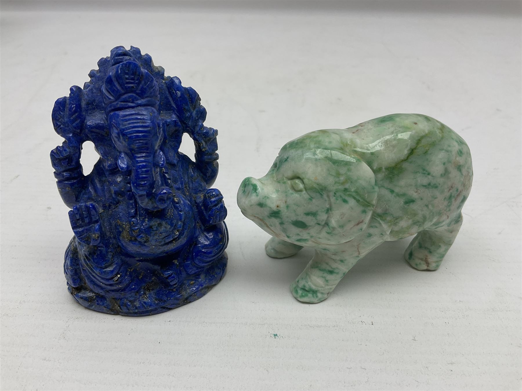 Carved Lapis lazuli figure in the form of Ganesha, together with turquoise carved buddha, tigers eye owl and other carved figures and plaques, Ganesha 8cm