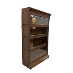 Early 20th century oak Globe Wernicke design sectional library bookcase, four sections each with hinged sliding glazed door, on moulded base 