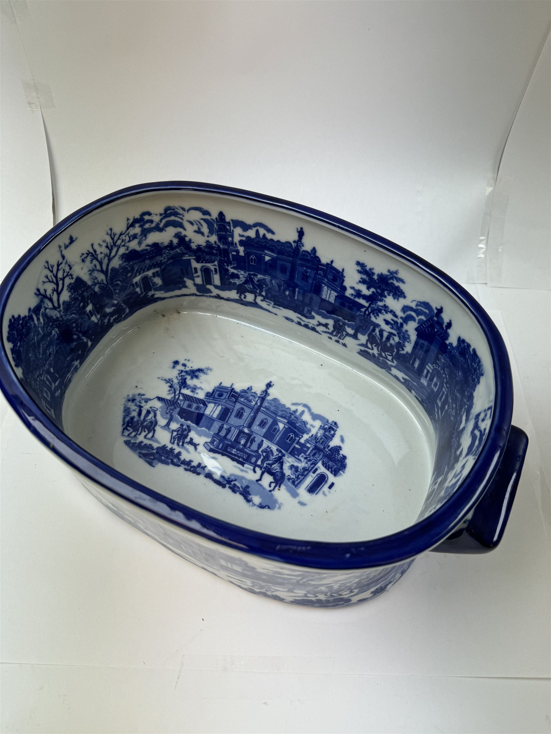 Pair of Victorian style blue and white footbaths, each with twin lug handles and transfer print decorated with city scape, H14cm