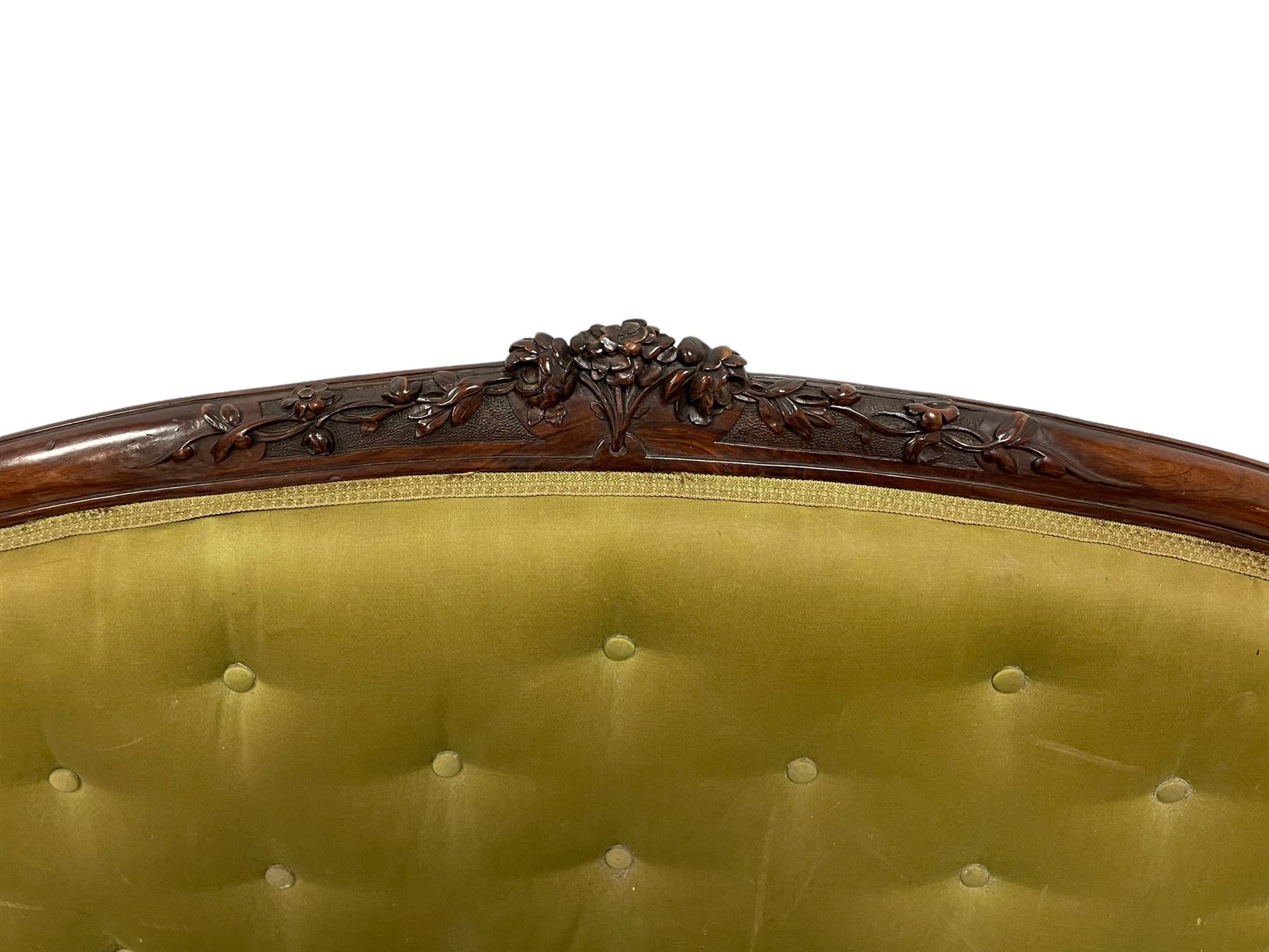 Victorian carved walnut framed two seat settee, cresting rail carved and moulded with a posy of roses and trailing foliate, over an oval back with scrolled arm terminals, serpentine fronted seat over cabriole supports with bell-flower carved knees, buttoned back and sprung seat upholstered in olive green fabric