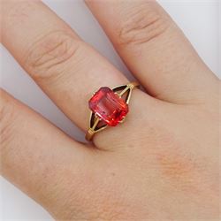 9ct gold single stone emerald cut red-orange sapphire ring, with forked shoulders