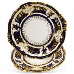 Royal Crown Derby tea service for twelve, circa 1930, comprising twelve teacups, saucers & tea plates, two serving plates, sugar basin and milk jug, each piece decorated with cobalt blue and gilt moulded borders, pattern no. 5732