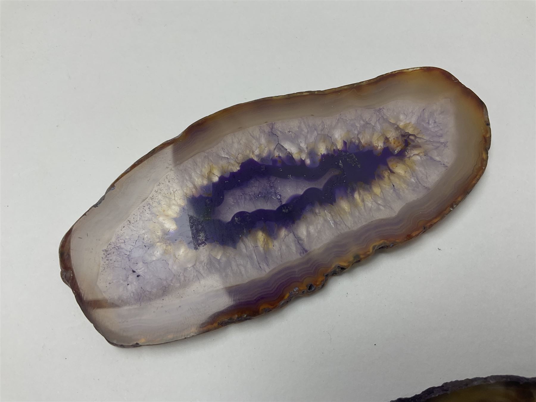 Three purple agate slices, polished with rough edges, of various sizes largest H7cm, L10cm