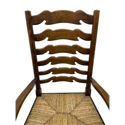 Matched set of eight (7+1) oak ladder back dining chairs, waved ladder back over rush seats, on turned supports joined by turned stretchers