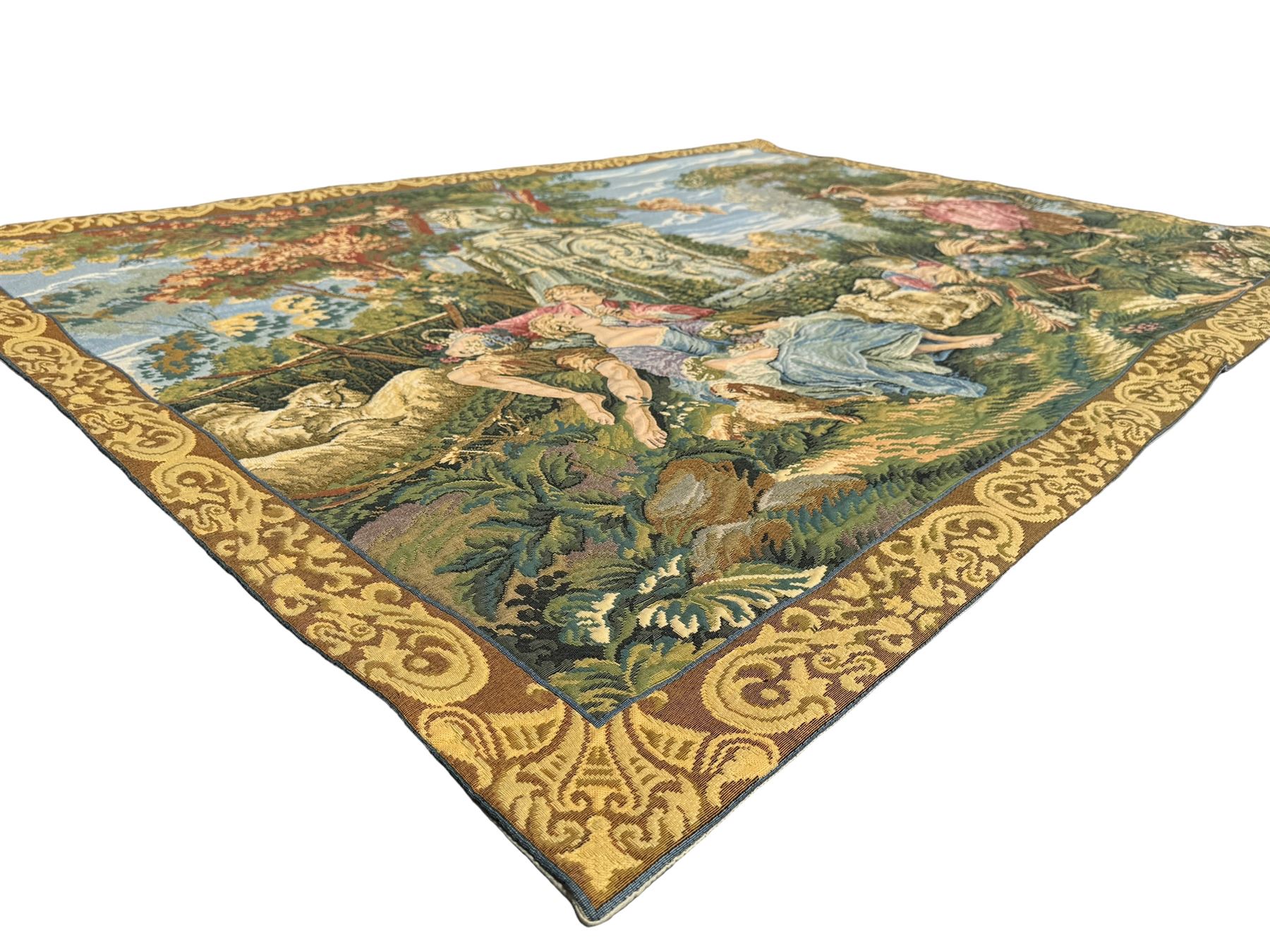 French machine woven tapestry, the scene depicting pastoral life with shepherds and sheep against a backdrop of lush foliage and classical architecture, bordered by a floral and scroll design