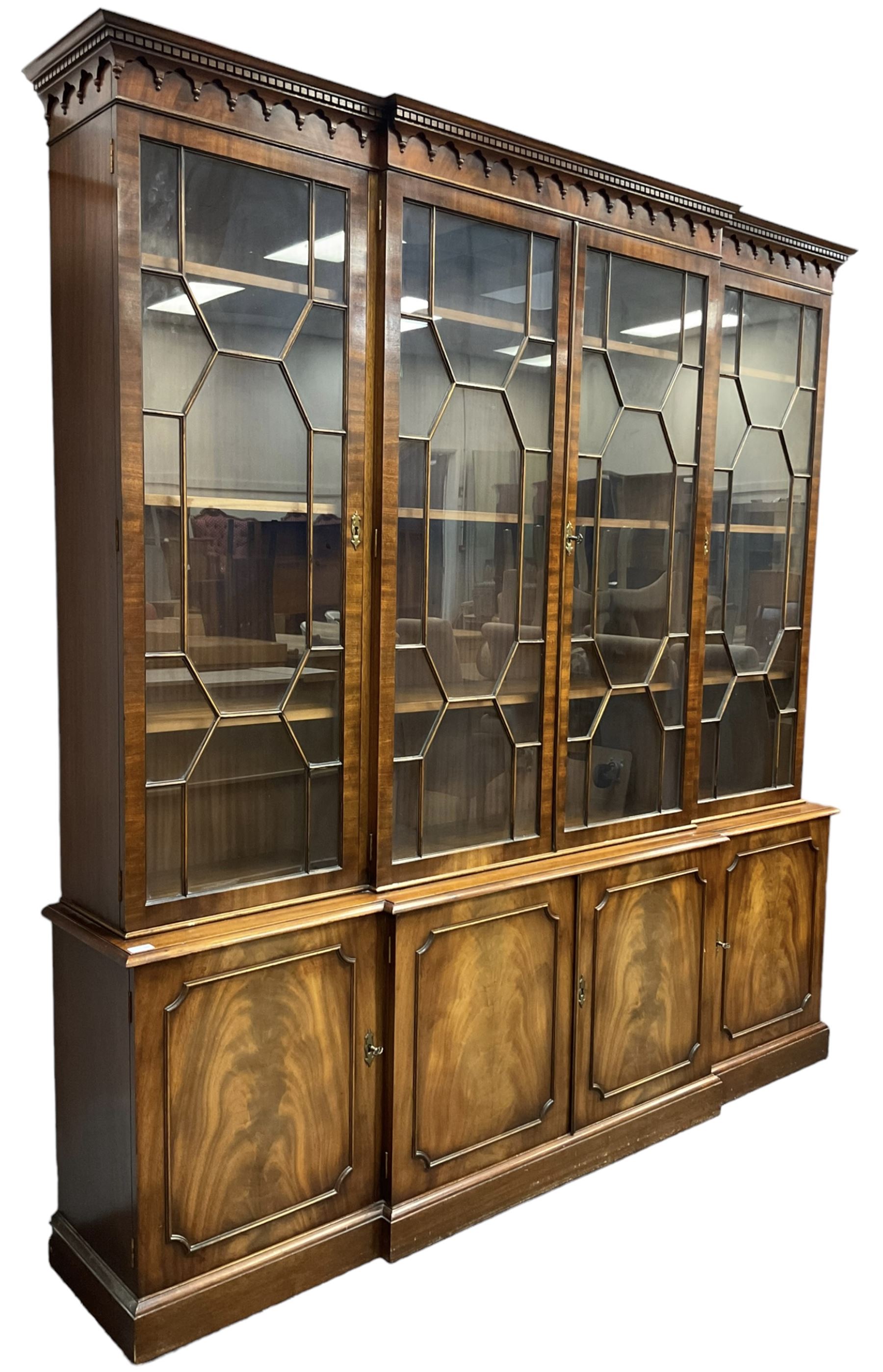 Bevan Funnell - Georgian design mahogany breakfront bookcase, moulded dentil and arcaded frieze over four astragal glazed doors, four cupboards below enclosed by figured doors, on skirted base