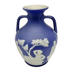 19th century Wedgwood dark blue dipped Jasperware Portland vase, of ovoid form with twin handles to shoulders and waisted neck, and flared rim, the body decorated with a continuous scene of classical figures in relief, the base decorated with portrait in relief, H26cm