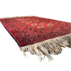 Afghan red ground Bokhara rug, decorated with four central Gul motifs, enclosed by wide geometric guard bands (191cm x 104cm); together with another similar (120cm x 79cm)