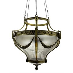 Edwardian brass ceiling light of circular bulbous form, moulded upper band over a guilloche cast central band united by shaped strapping, decorated with fruiting foliage festoons, fitted with frosted and vertical bevelled glass bowl, acanthus cast finial 