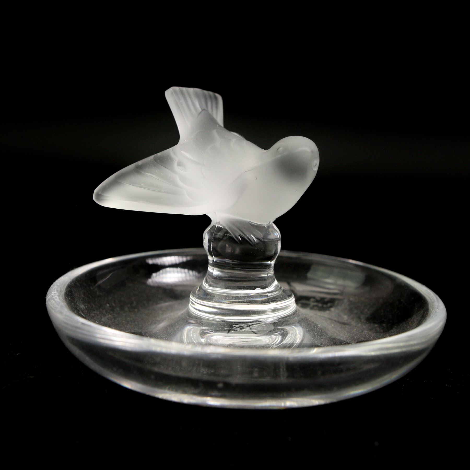 Lalique glass to include three pin dishes surmounted with swans, lovebirds and wren, another figure of a wren on circular base and a Nina Ricci dove perfume bottle, H9cm (5)