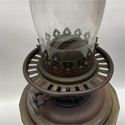 Victorian oil lamp, the faceted reservoir upon embossed copper stem and stepped circular ceramic base, with etched floral glass shade