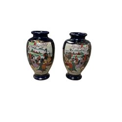 Pair of Japanese vases decorated with figures in a landscape, H38cm