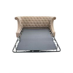 Grande wing back sofa bed, upholstered in beige buttoned fabric, metal action pull out double bed