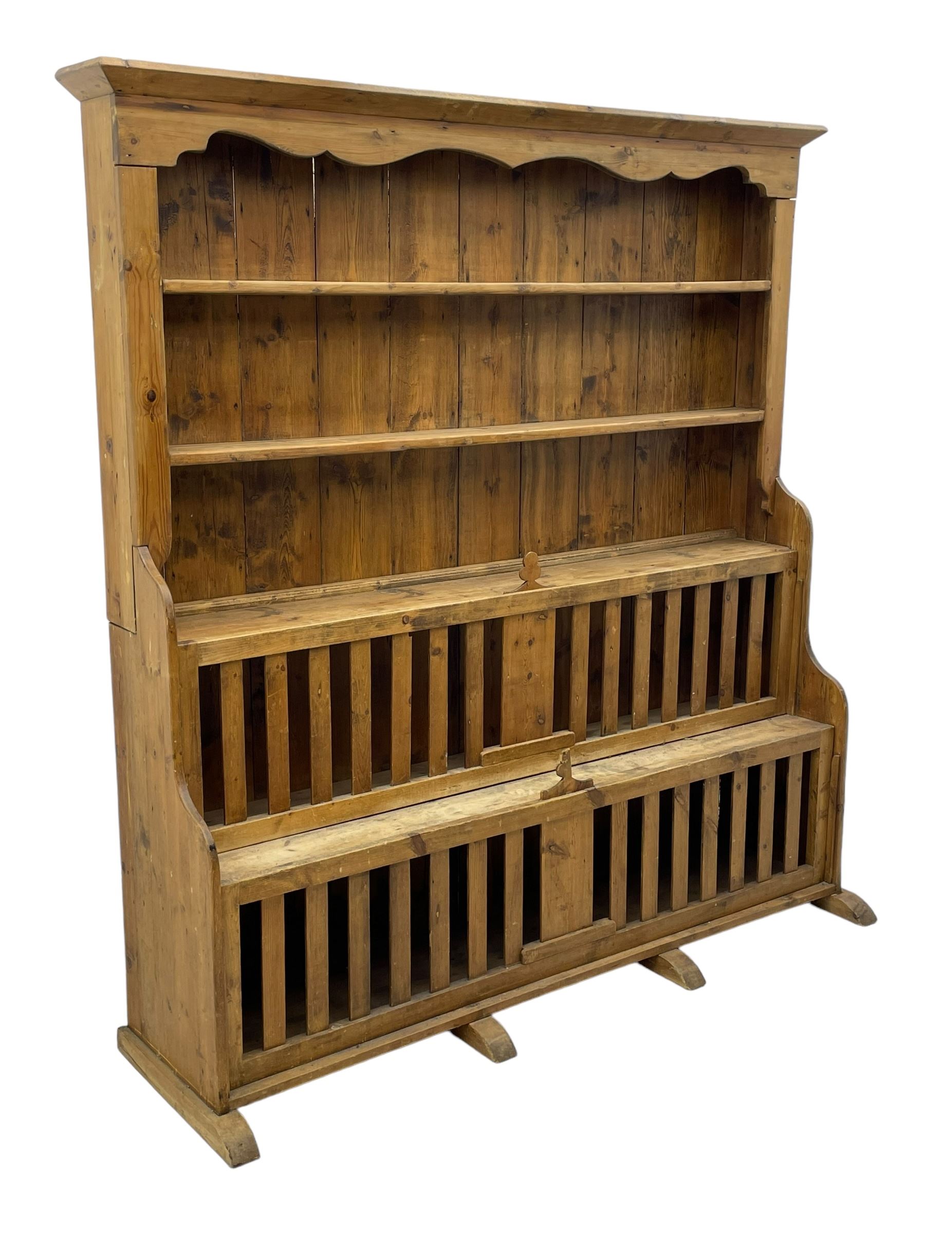 Waxed pine 'chicken coop' or 'hutch' dresser, projecting cornice over shaped frieze and three tier plate rack, the stepped waterfall lower section fitted with two slatted chicken coops, on sledge feet 