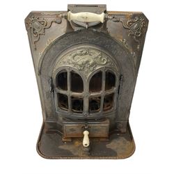 La Salamandre - early 20th century cast iron wood burning stove, decorated with salamander and cartouche motifs, fitted with porcelain handle, on rear castors 