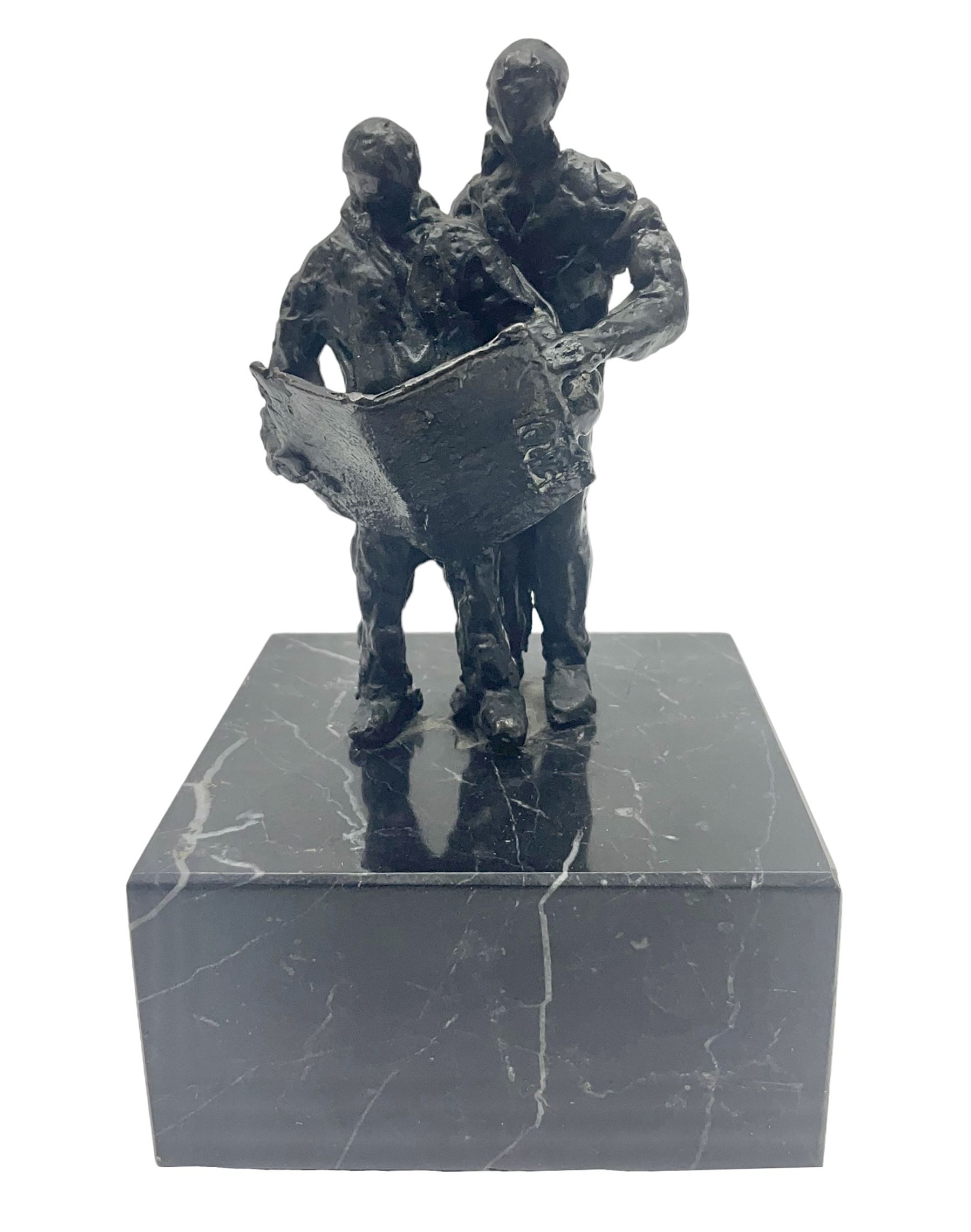 20th century bronze sculpture, modelled as two figures reading, upon a black and white marble base, H14cm