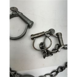 Hiatt handcuff and leg chains, together with leather collar with brass cow bells and similar items 