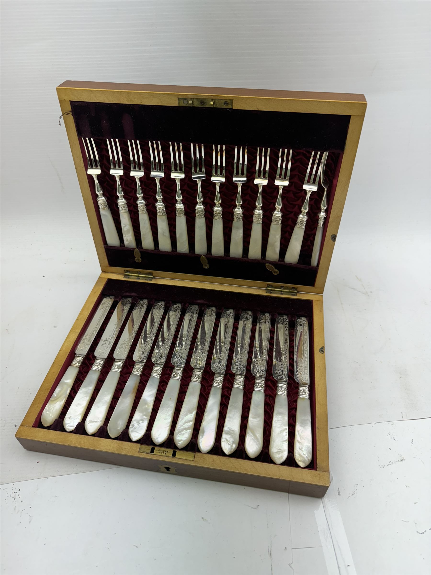 Set of twelve early 20th century century mother of pearl handled and silver plated fruit knives and forks, housed in a satin and velvet lined mahogany case, together with a 