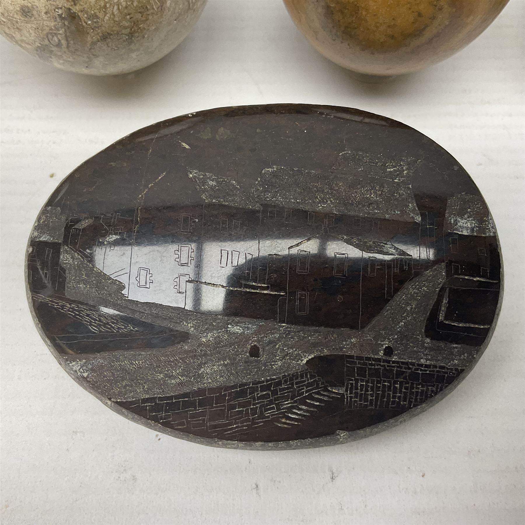 Fossilised coral egg, together with three onyx eggs, mineral bookends and a carved stone