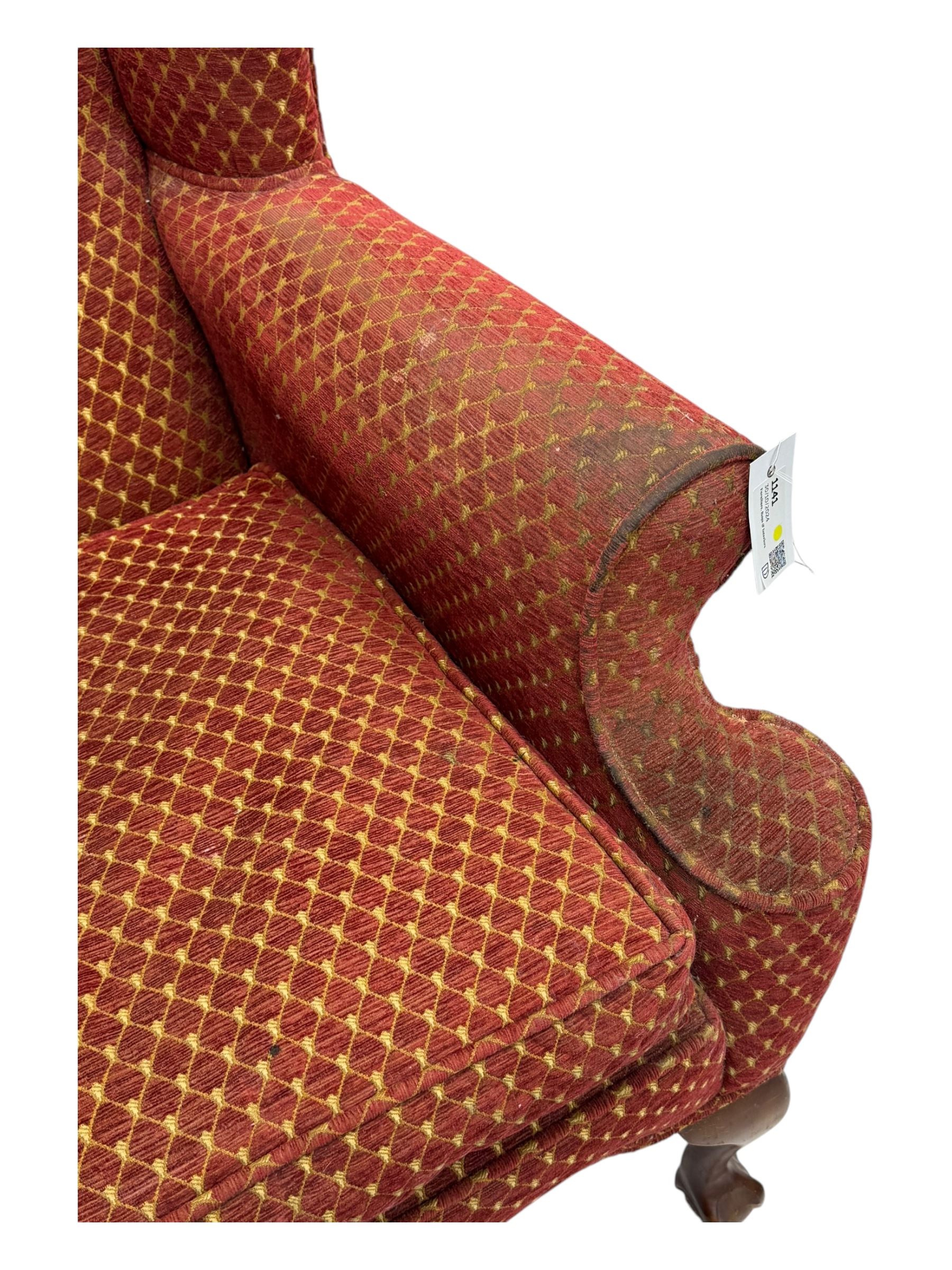 Early 20th century hardwood-framed wingback armchair, upholstered in red dotted fabric, on cabriole feet