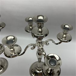 Pair of four branch candelabras, urn-shaped nozzles raised upon scroll branches supported from tapering central stem, with a stepped circular base, H40cm