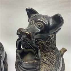 Pair of unusual early English pottery figures, modelled in the form of seated dogs with baskets between their jaws, the tails forming whistles, each upon rectangular base, overall H22cm