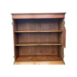 Early 19th century mahogany bureau bookcase, the projecting cornice over two Gothic-style astragal glazed doors enclosing two adjustable shelves, sloped hinged lid enclosing fitted interior and felt inset, four graduating drawers, on bracket feet