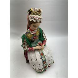 Anna Meszaros (Hungarian 1905-1998): Young Woman Holding Flowers, handmade needlework figurine, together with two badges awarded to the artist in needlework competitions, figure H29cm
Auctioneer's Note: Anna Meszaros came to England from her native Hungary in 1959 to marry an English businessman she met while demonstrating her art at the 1958 Brussels Exhibition. Shortly before she left for England she was awarded the title of Folk Artist Master by the Hungarian Government. Anna was a gifted painter of mainly portraits and sculptress before starting to make her figurines which are completely hand made and unique, each with a character and expression of its own. The hands, feet and face are sculptured by layering the material and pulling the features into place with needle and thread. She died in Hull in 1998