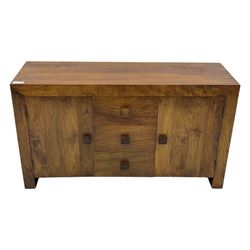 Contemporary Dakota mango wood sideboard, plain rectangular top over three central drawers flanked by cupboards with shelving, each with square pulls, raised on stile supports