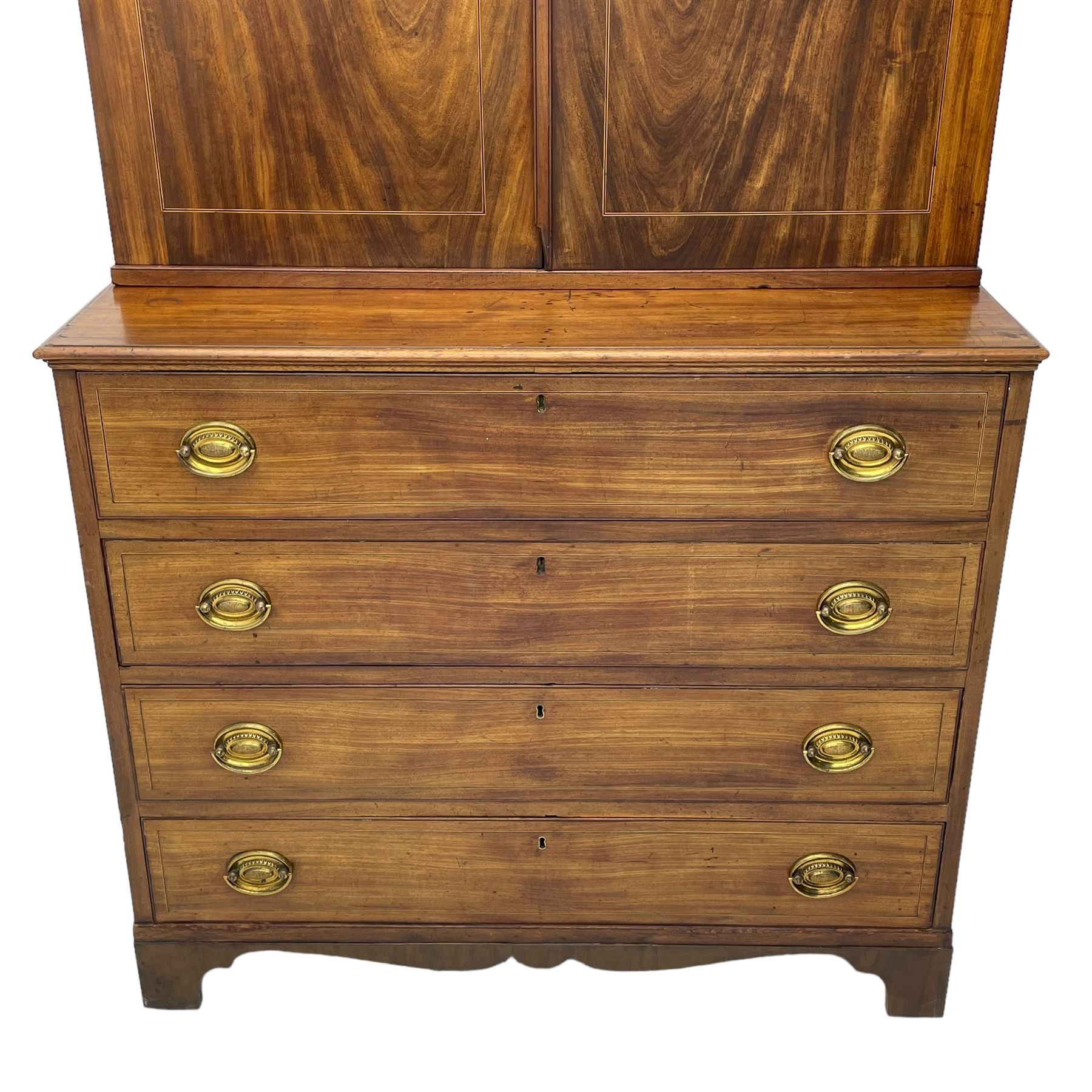 George III figured mahogany secretaire bookcase, projecting moulded dentil cornice decorated with single row of roundels, two figured mahogany doors with boxwood and ebony stringing enclosing three adjustable shelves and three drawers, moulded rectangular top over four long scratch-moulded drawers, the top secretaire drawer with fall front enclosing small drawers, pigeon holes and inset writing surface, shaped apron with bracket feet