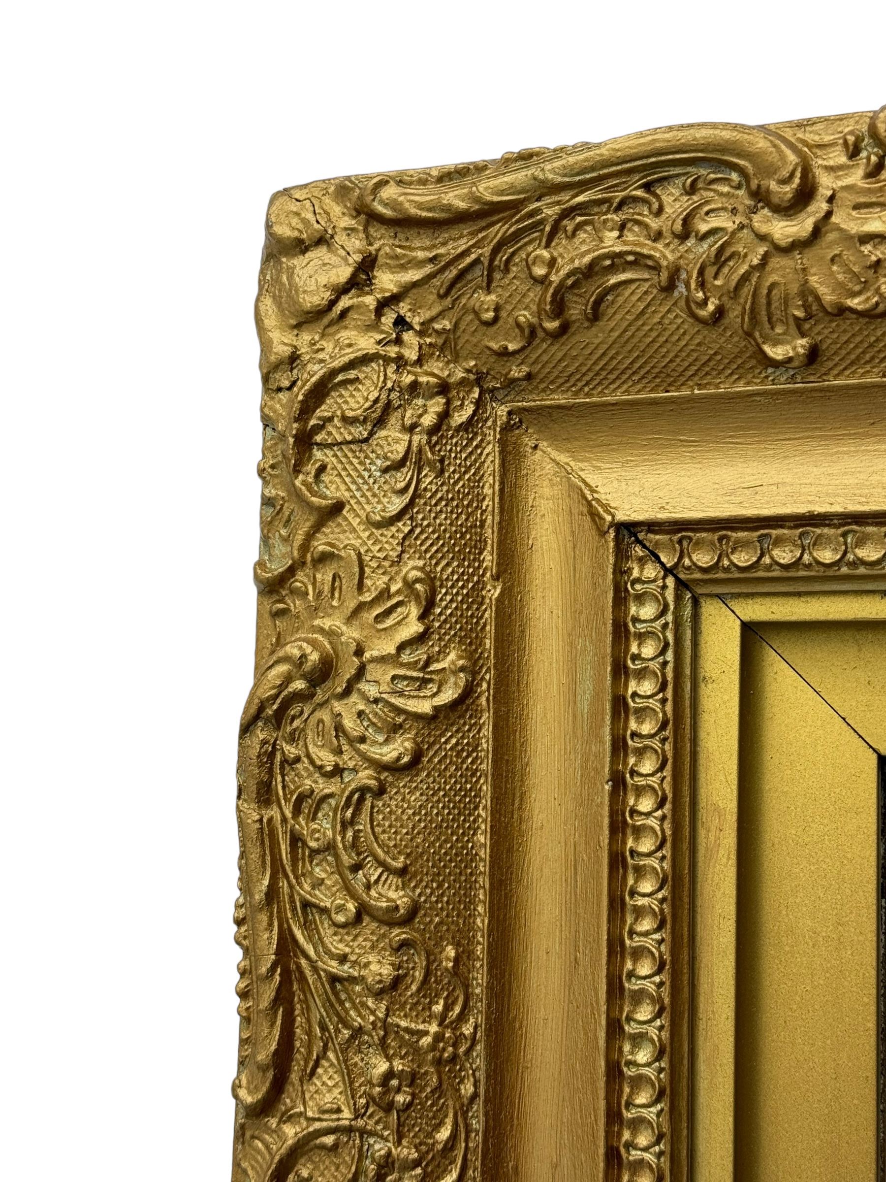 Rectangular wall mirror, in ornate gilt frame decorated with trailing leafy branches and flower heads 