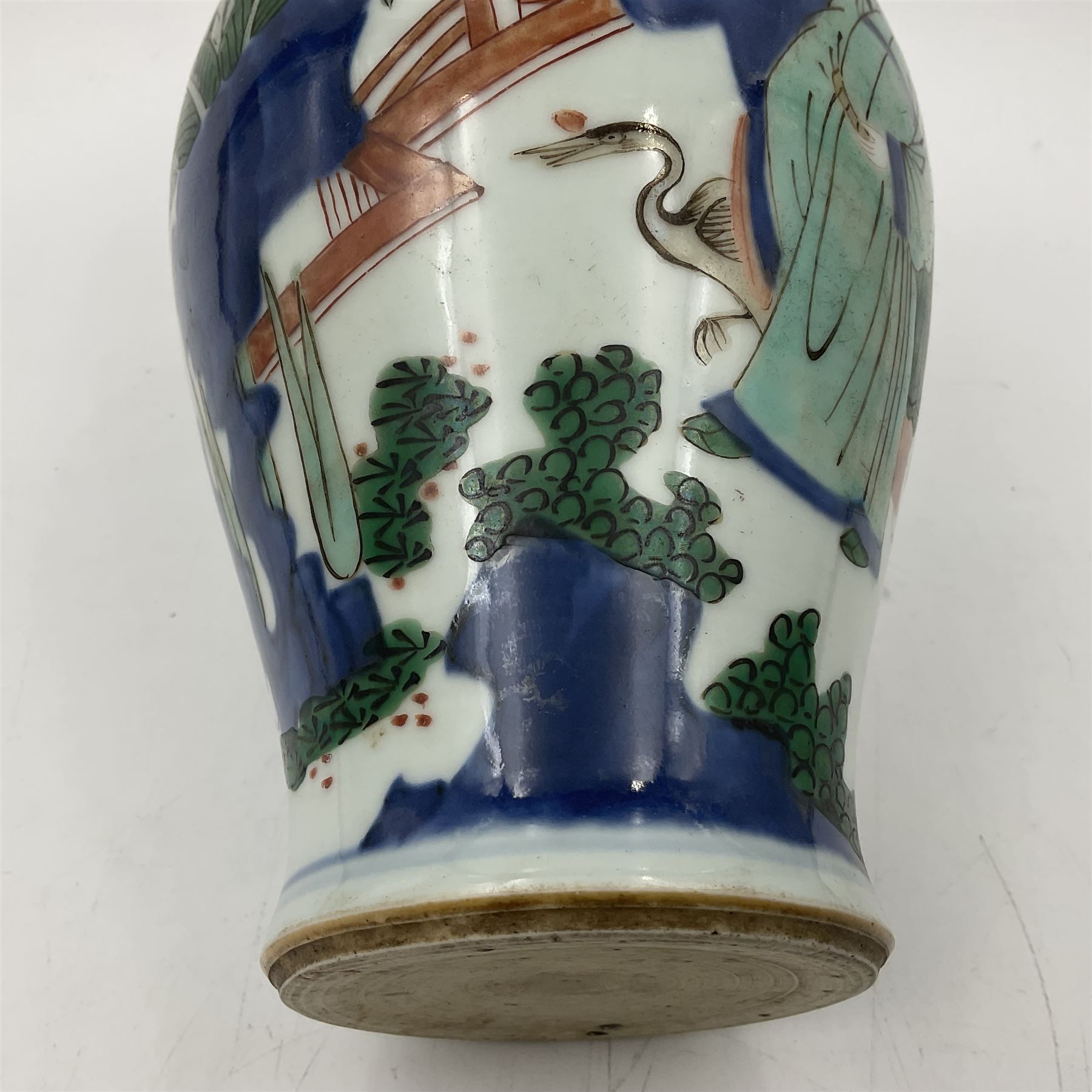 Chinese Wucai vase, of baluster form, decorated with an official and attendants in a garden setting, with crane, fence and rockwork, H19cm