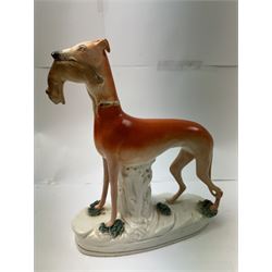 Pair of standing Staffordshire whippets with rabbits in their mouths, together with a pair of Staffordshire spaniels, whippets H30cm