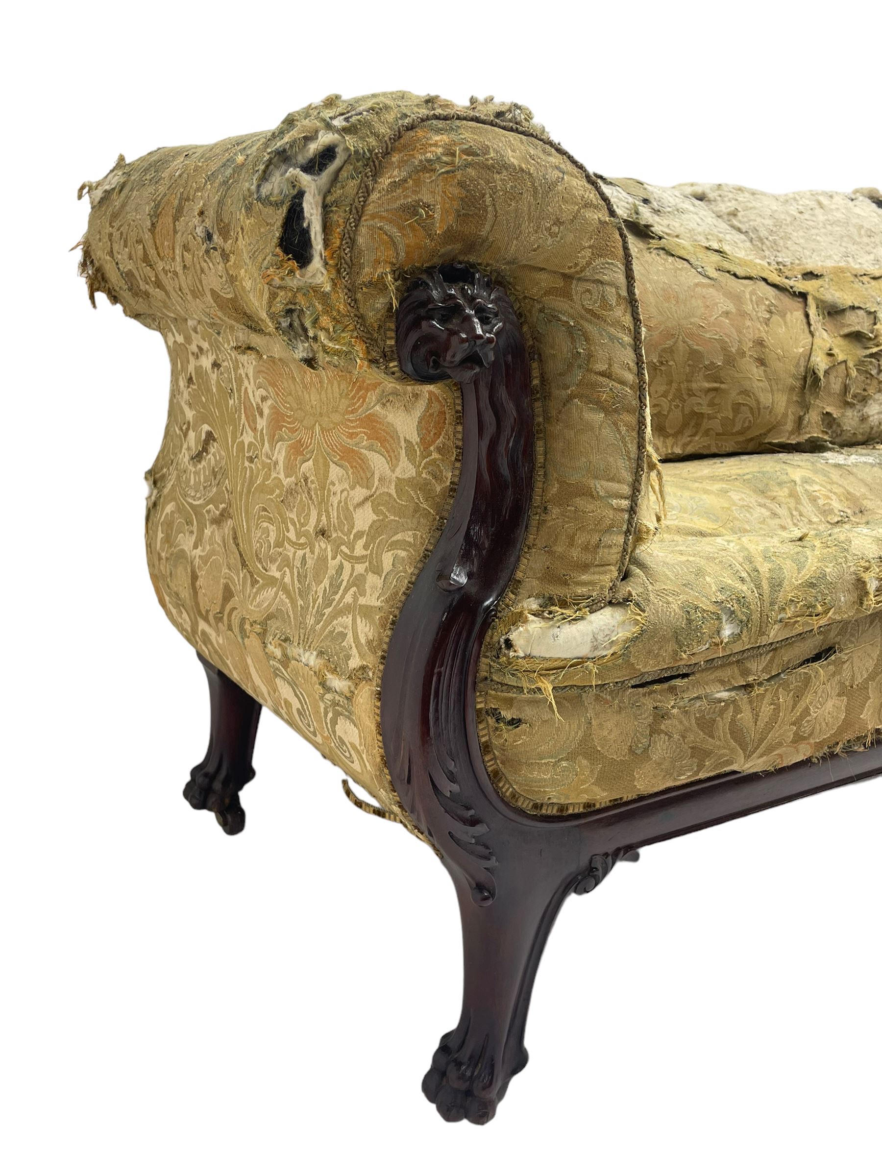 19th century mahogany settee, rolled S-scrolled arms carved with lion masks and acanthus leaf scrolls, the lower moulded rail carved with scrolling design, raised on carved paw feet with recessed brass and ceramic castors 