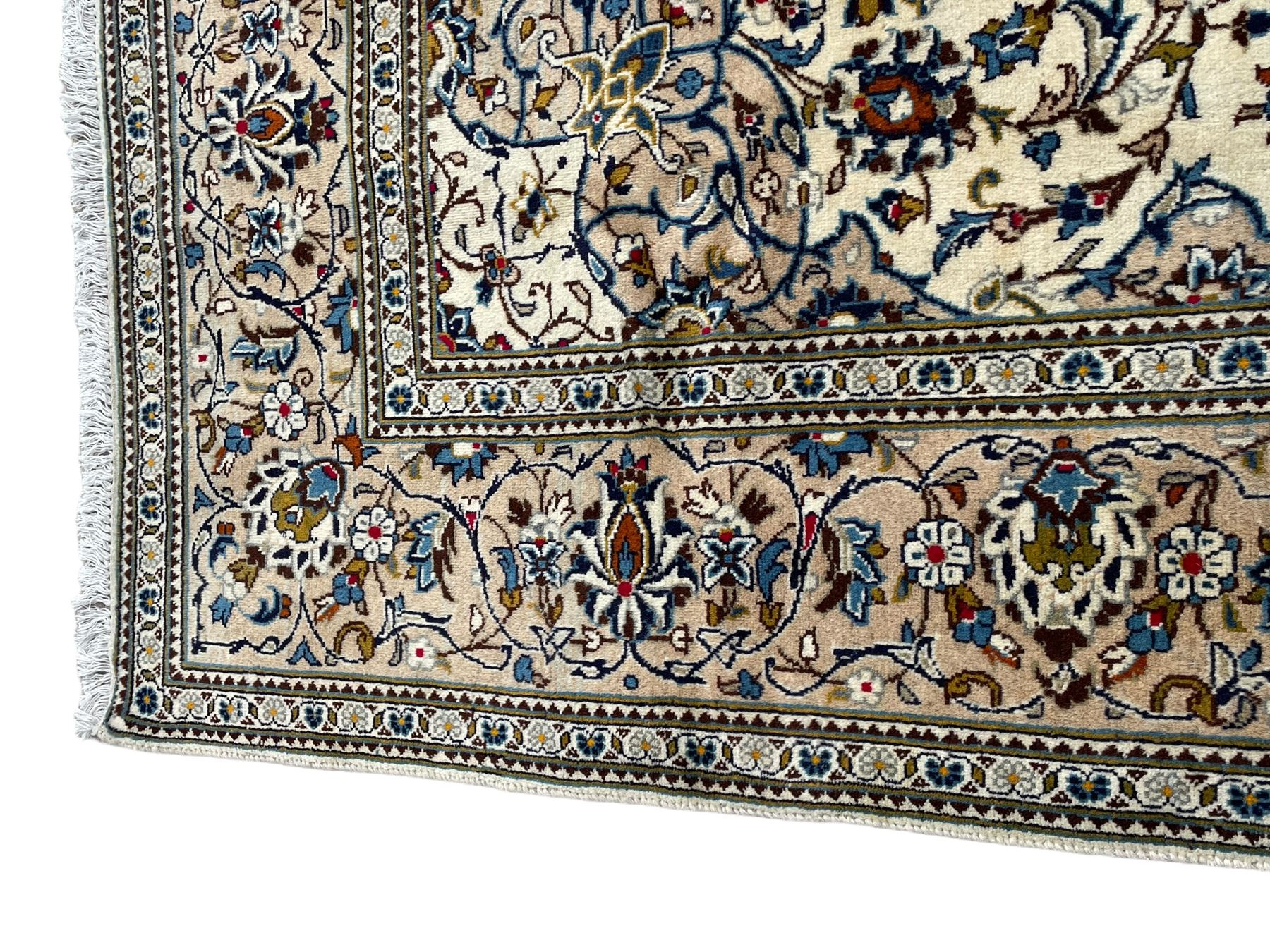 Persian Kashan ivory ground rug, central floral medallion surrounded by interlacing leafy branches and stylised plant motifs, scrolling spandrels, the border decorated with trailing branch and repeating palmettes, within floral pattern guard stripes 