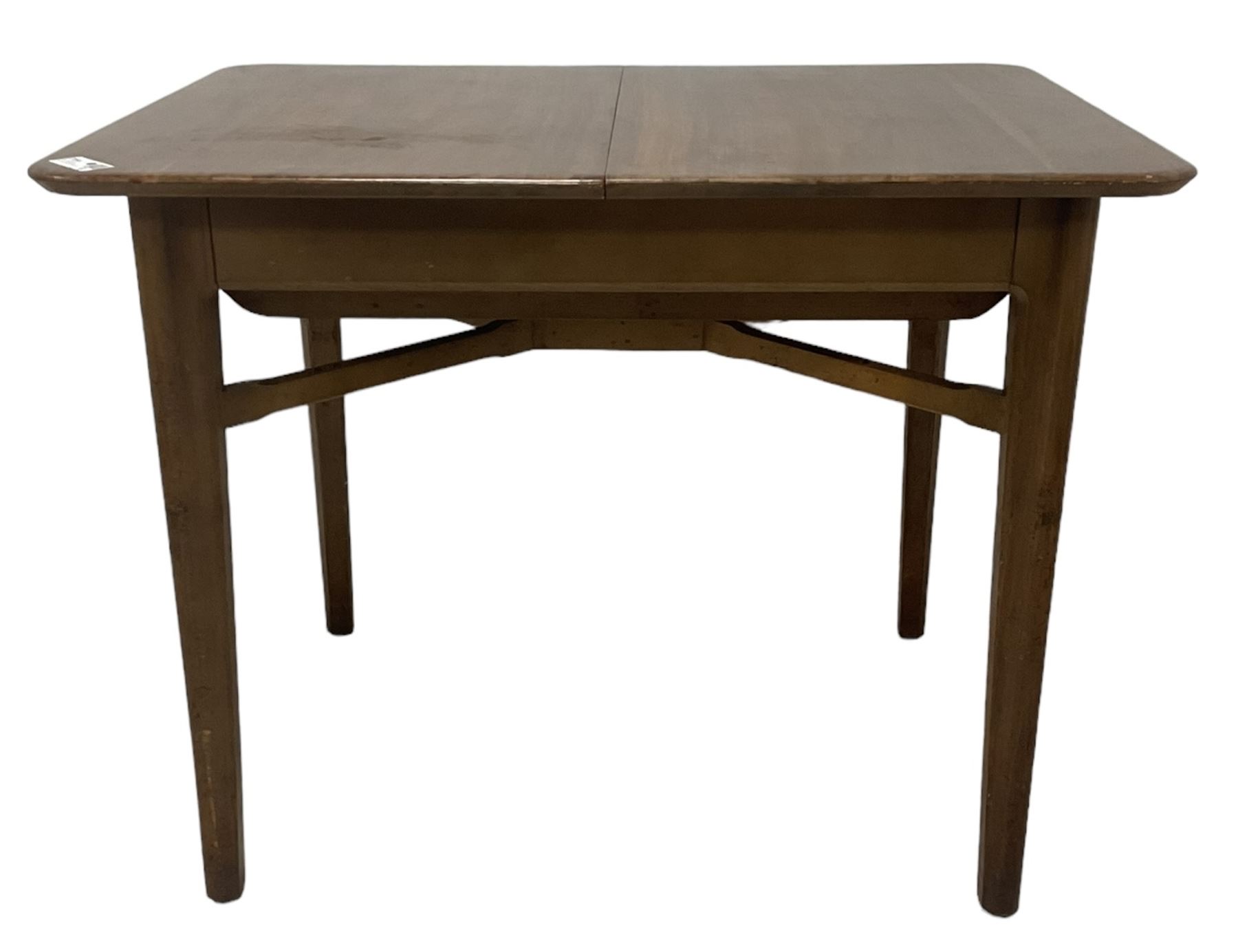 Mid-20th century teak extending dining table, rectangular top with rounded corners, raised on shaped tapering supports united by X-stretcher, with additional leaf