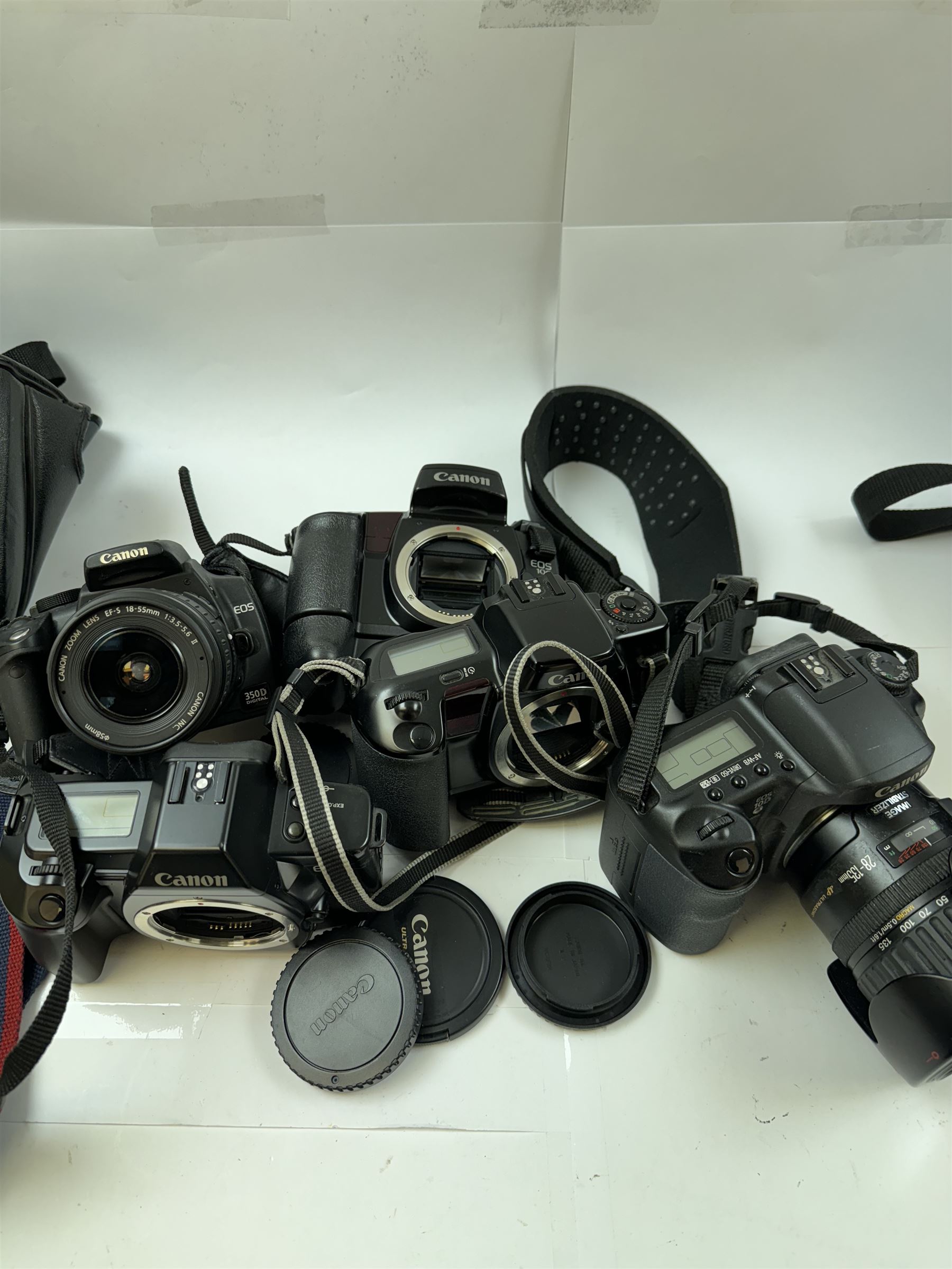 Five Canon EOS cameras, comprising EOS 100 camera body, serial no. GR-70, EOS RT camera body, serial no. 2539432, EOS 350D, serial no. 1330744265, with a Canon EF-S 18-55mm 1:3.5-5.6 II zoom lens, serial no. 1230500053, EOS 10 camera body, serial no. 1274983, and an EOS 10D camera serial no. 1430501397, with a Canon Ultrasonic 72mm EF 28-135mm 1:3.5-5.6 IS zoom lens, serial no. 3402517E