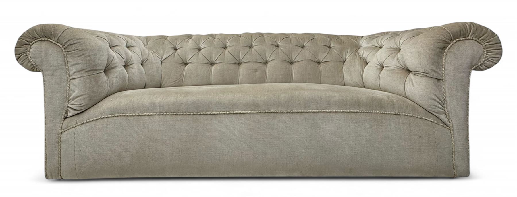 Chesterfield shaped button-tufted sofa, upholstered in pale beige velvet fabric with rolled arms, decorative rope trim and ruched detailing