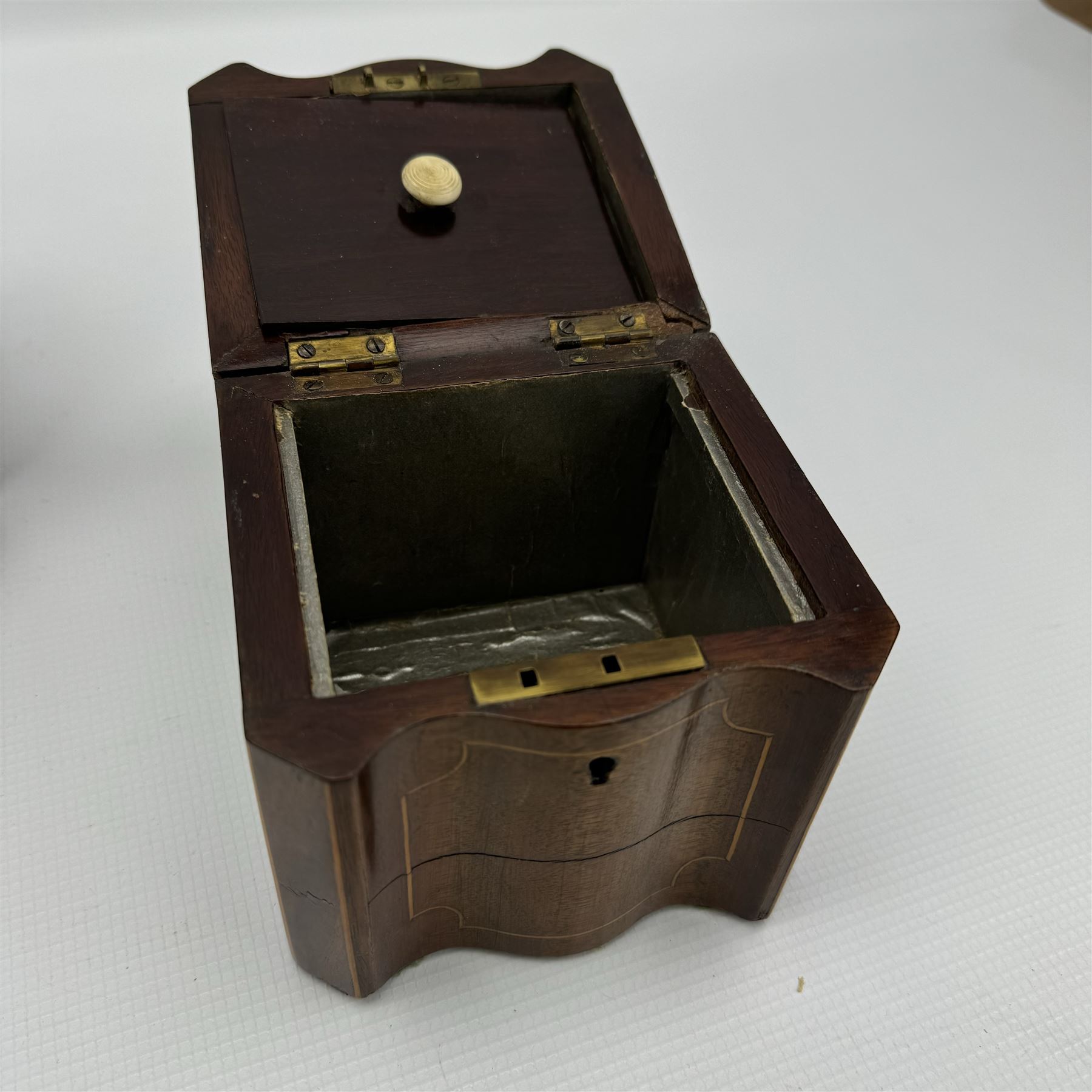 Late Georgian burr walnut sarcophagus shape tea caddy W26cm and a mahogany caddy of serpentine outline W12cm