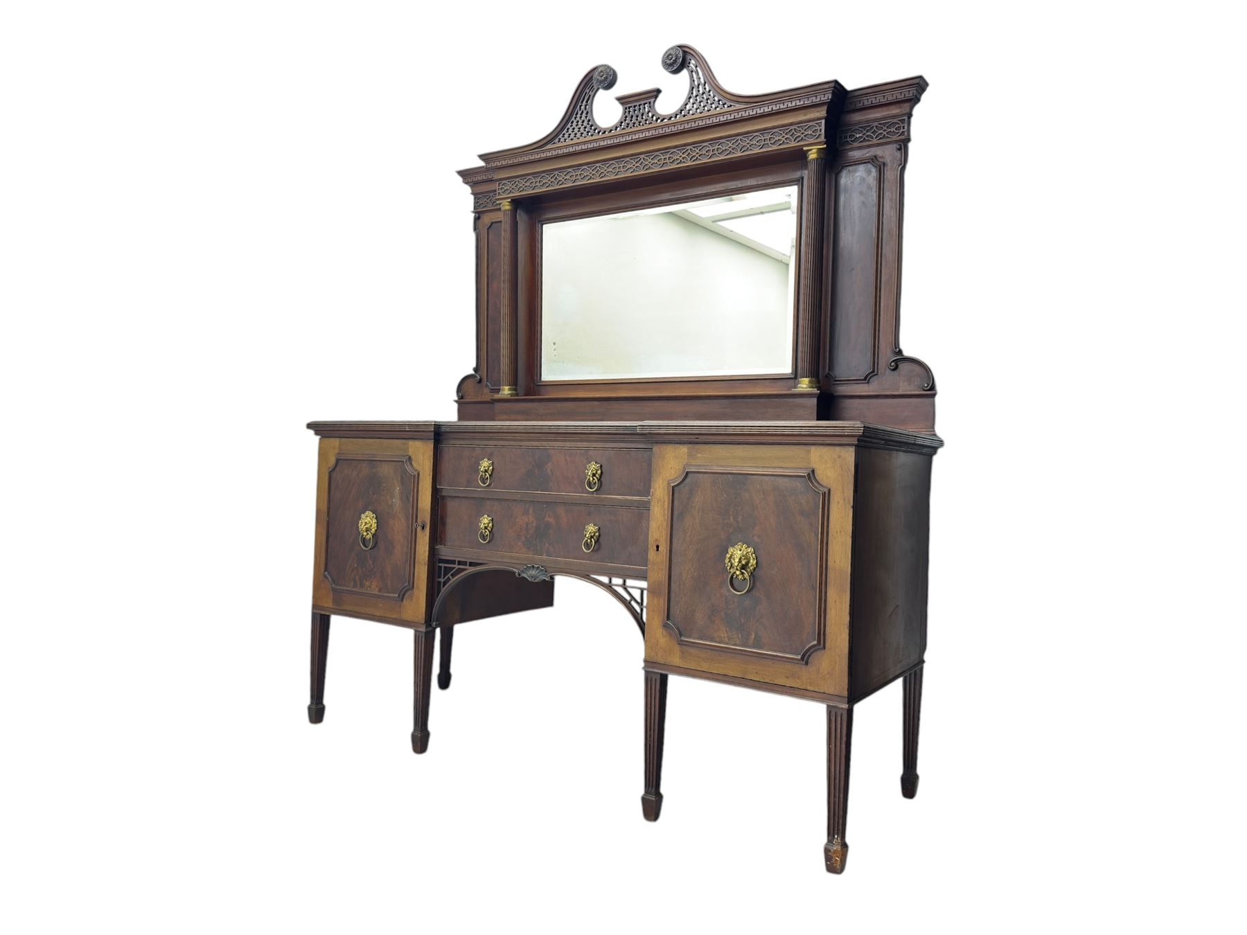 19th century mahogany sideboard, raised mirror back with carved fretwork and two fluted columns, above two cupboards and two drawers with lion mask handles