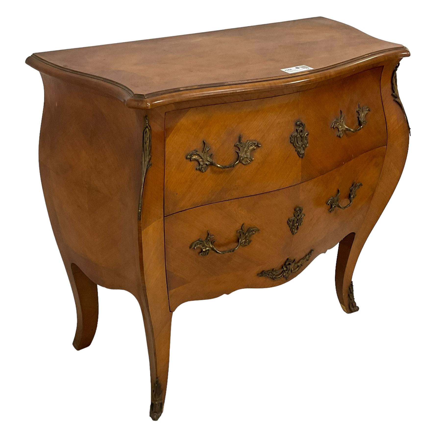 Late 20th century French design walnut bombe chest, shaped moulded top with quarter-matched veneers within crossbanding, fitted with two drawers with foliate cast metal handles and escutcheons, on tapering supports with ornate cast caps 