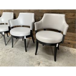 Four ebonised framed tub shaped armchairs, upholstered in grey fabric