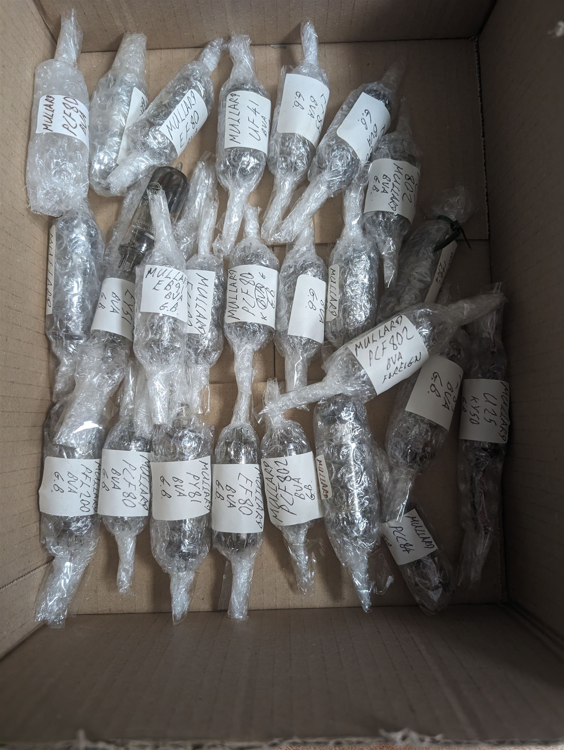 Collection of Mullard thermionic radio valves/vacuum tubes, mostly bubble wrapped and identified with lists