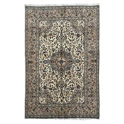 Persian Kashan ivory ground rug, central floral medallion surrounded by interlacing leafy branches and stylised plant motifs, scrolling spandrels, the border decorated with trailing branch and repeating palmettes, within floral pattern guard stripes 