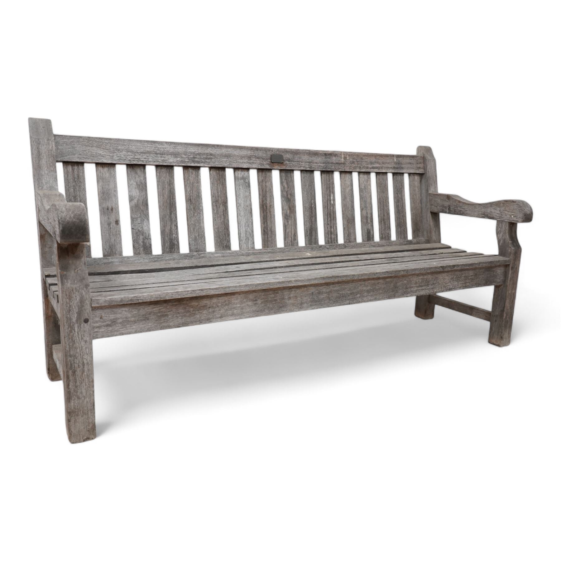 'J.V.T. Ampleforth' - teak garden bench, plain cresting rail with applied maker's plaque over slatted back and seat, on square supports 