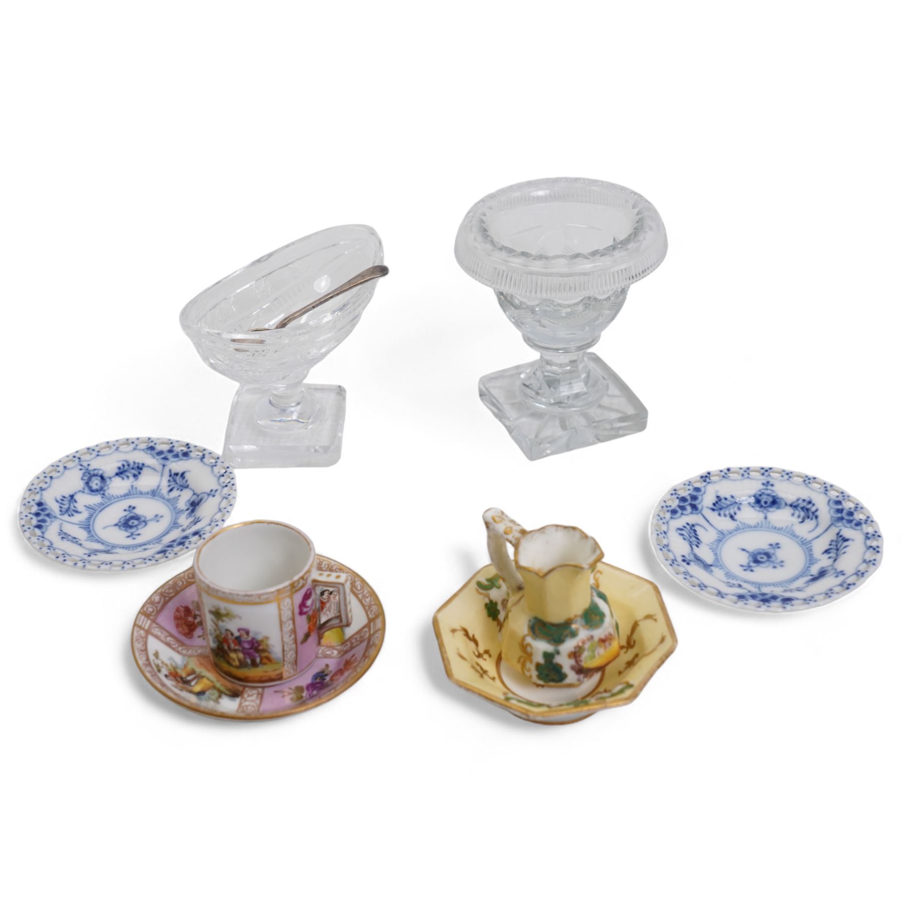 Two Georgian cut glass table salts, one of boat form on square pedestal base, the other with folded rim and square star cut base, with a later silver salt spoon, pair of Royal Copenhagen blue full lace dishes, no. 1004, D7.5cm, Augustus Rex style miniature coffee cup and saucer, together with a 19th century miniature jug and bowl, with hand painted panels 