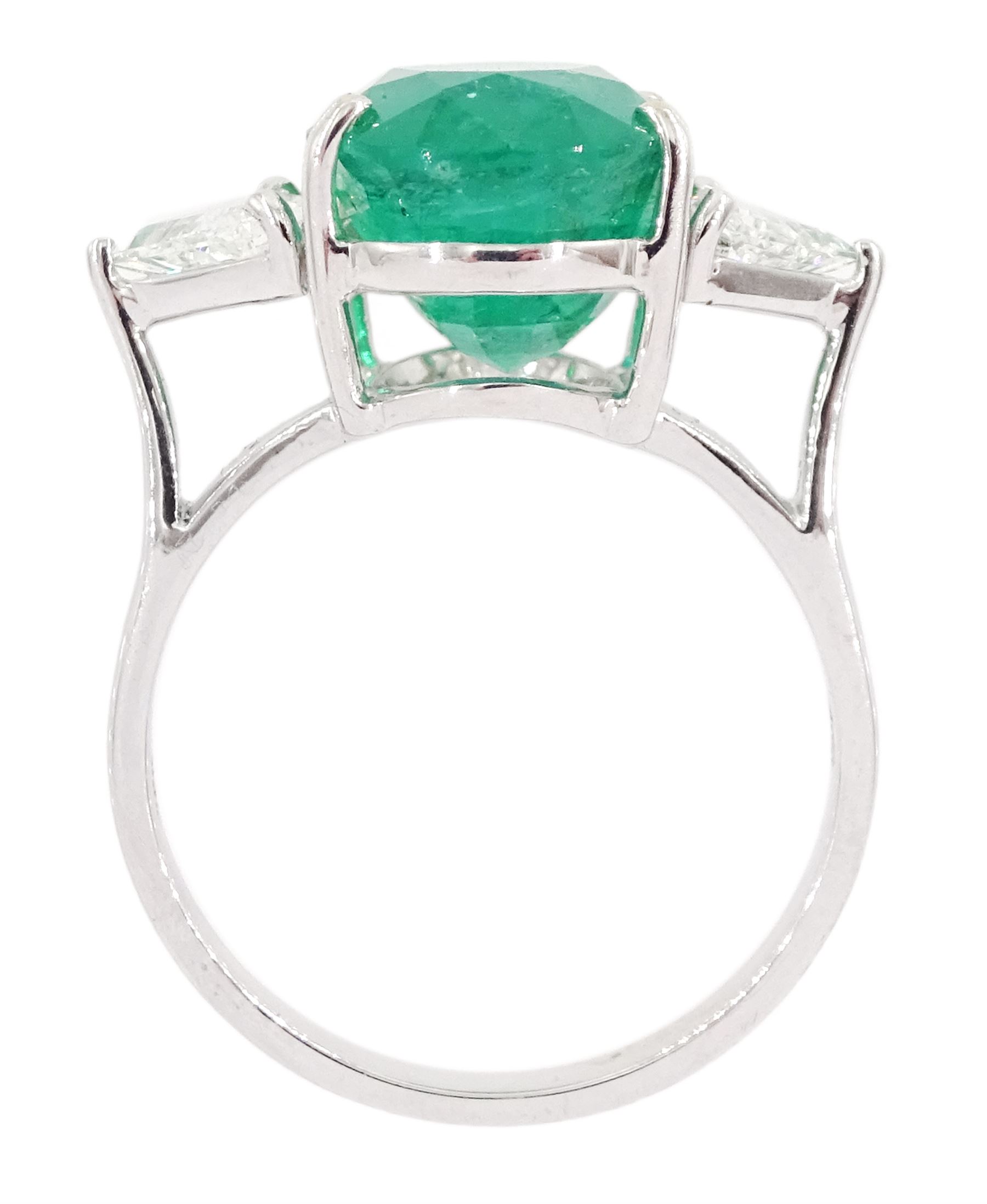 18ct white gold three stone oval cut emerald and trillion cut diamond ring, stamped, emerald approx 5.65 carat, total diamond weight approx 0.65 carat