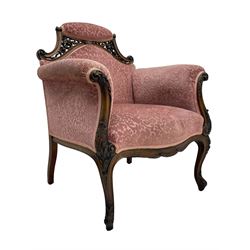 Late 19th century carved walnut framed armchair, the upper spandrels pierced and carved with curled acanthus leaves, upholstered in pink foliate pattern fabric, acanthus leaf carved and scrolled arm facias terminating to cabriole supports, leaf carved terminals 