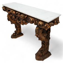 Early 20th century Baroque design ornate giltwood console table with rectangular marble top, the heavily moulded protruding and pierced frieze decorated with a central crowned foliage cluster with extending scrolling acanthus leaves, the shaped end supports decorated with further moulded gilt foliate scrolls interspersed with flower heads, on shaped stepped bases carved with floral patterns 