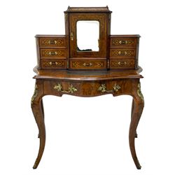 19th century French figured walnut Bonheur de Jour or writing desk, the upper section with brass gallery over mirror glazed cupboard and a combination of drawers, shaped and moulded top with leather inset and satinwood band, fitted with single drawer, on cabriole supports, inlaid throughout with scrolling foliate decoration in boxwood, ornate cast brass mounts 